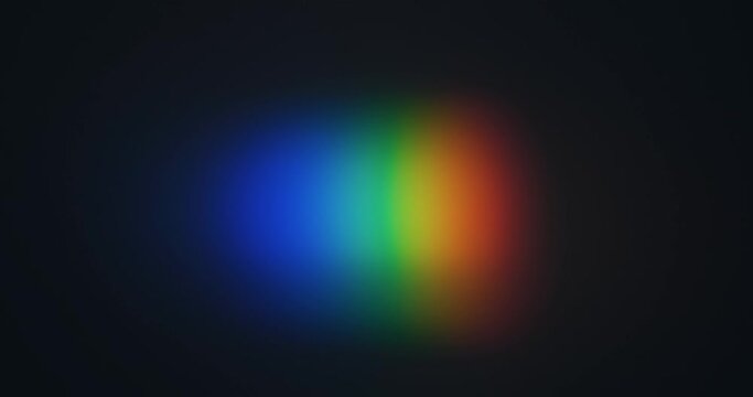 Shining a spot of light in the form of a rainbow. Spectral decomposition of light into rainbow colors. Black background