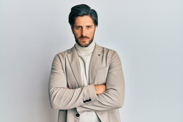 Young hispanic man with arms crossed gesture skeptic and nervous, frowning upset because of problem. negative person.