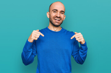 Young hispanic man wearing casual clothes looking confident with smile on face, pointing oneself with fingers proud and happy.