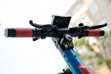 An E-scooter parked in the sidewalk in London.