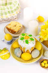 Easter cake with raisins in sugar glaze. festive pastries, eggs, flowers and Easter decor on a white background. religious holiday 