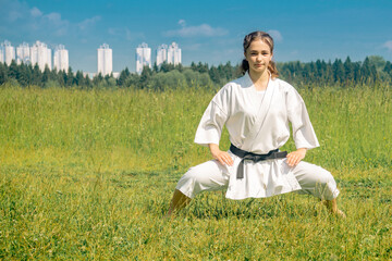 teen girl practicing karate kata outdoors in kiba-dachi stance © Evgeny