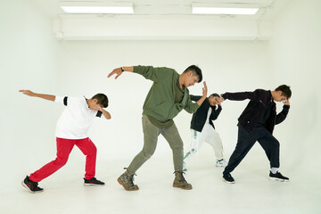 Action group of dancing class in white room studio with trainer and childen
