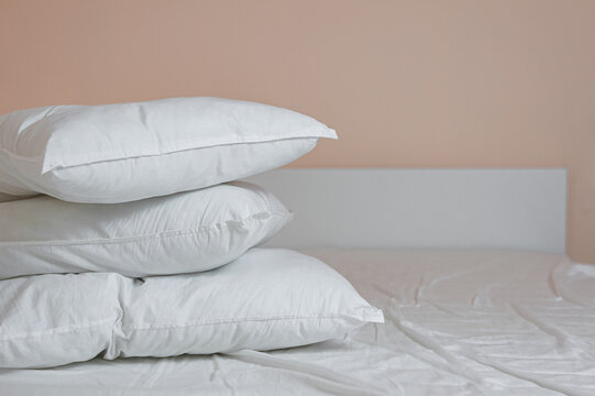 Neat Stack Of Bedding Pillows And A Duvet Lie On The Bed