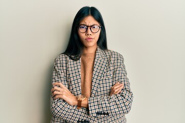Young chinese woman wearing business style and glasses skeptic and nervous, disapproving expression...