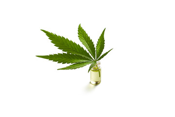 Cannabis oil bottle and marijuana leaf on white background. Isolated