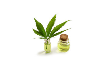 Cannabis oil bottle and marijuana leaf on white background. Isolated