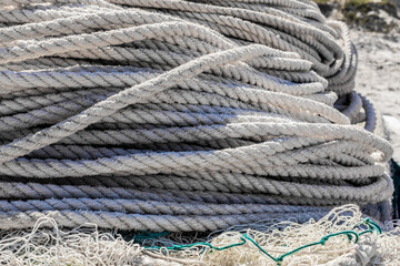 Fototapeta na wymiar traditional fishing net and rope on small rowing boat