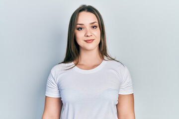 Obraz premium Young hispanic girl wearing casual white t shirt with a happy and cool smile on face. lucky person.