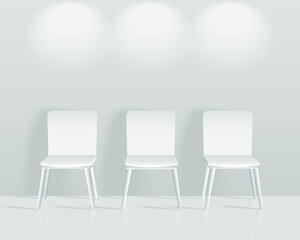 Chairs to face a blank gray wall