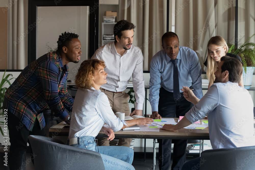 Poster Smiling diverse colleagues brainstorming working with project results and statistics at meeting in modern boardroom together, analyzing financial report, employees discussing marketing plan strategy