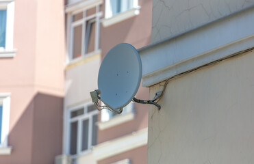 Satellite dish on the wall of the house. Technologies