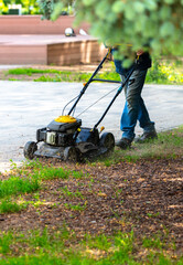 A lawnmower is cutting the grass