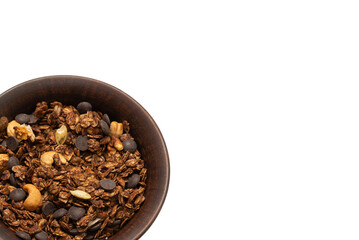 Chocolate granola cereal with nuts in a bowl background.