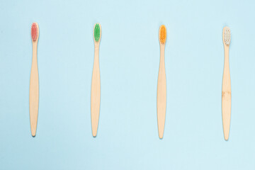 Bamboo toothbrush on a blue background. Top view.