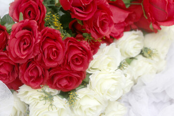 red roses and white roses on a white cloth