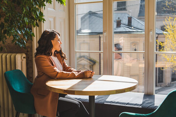 woman sitting in cafe near window