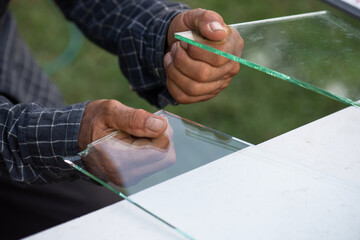 a construction worker is using glass cutting tools