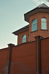 roofs of a new brick building in the first rays of the sun