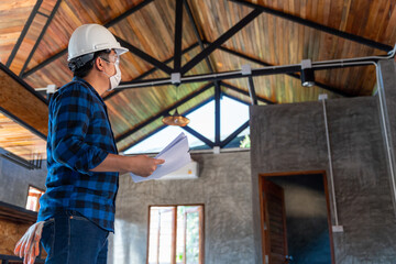 Construction engineer technician inspect the structure under the roof at construction site or building site of a house.