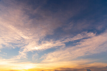 sunset / sun rise sky with rays of yellow and red light shining clouds and sky background and texture