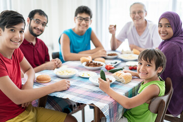 Happy family enjoying eating food in dining room