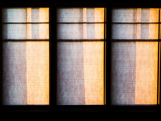 Drawn Window Shades at Dawn With Dramatic Shadows and Lighting
