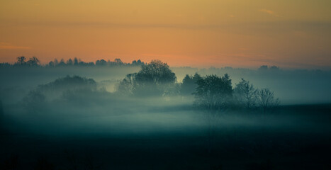 Cool, misty morning in the summer. Sunrise landscape with a mist. Summertime scenery of Northern Europe.