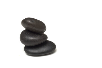 Closeup of black pebbles balance on white background