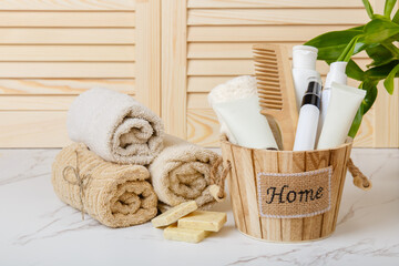 Natural Soap, towels and bath oil, bodycare products on background of bathroom wooden louvered...