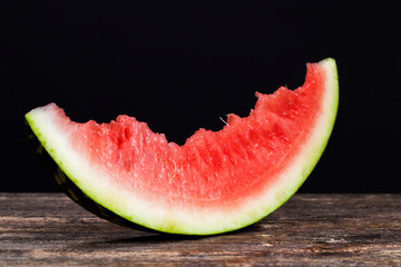 bitten piece of red watermelon