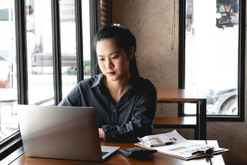 A young woman works with a laptop seriously. work online concept