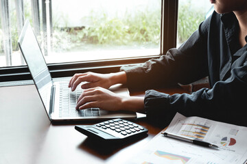 A young woman works with a laptop seriously. work online concept