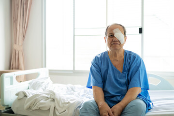 An old Asian man put a protective shield over her eyes to cover the cover to protect during nap...