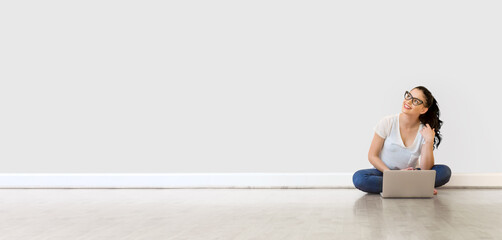 Fototapeta premium Young woman using her laptop