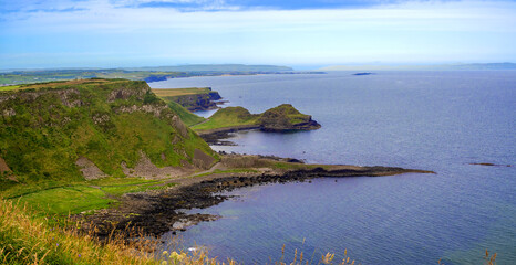 Panorama of Atlantic coastline in Northern Ireland with Giant’s Causeway, unique natural geological formations of volcanic basalt rocks, resembling cobblestones, gulf, bays, peninsulas and cliffs