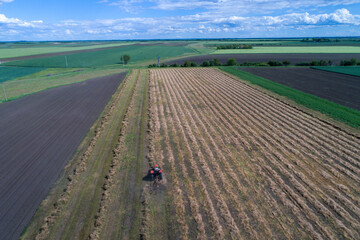 Aerial image of tractor with hay tedders