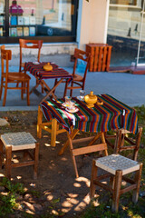 Traditional Turkish tea glasses. On the table of a street cafe, summer day