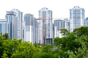 Cranes on a construction site of building of modern residential district