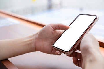 Cropped shot of female hand holding blank screen smartphone