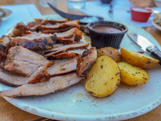 steak cut with potatoes and mushrooms and salt  in the plate