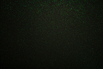 Green sparkling lights festive background with texture.