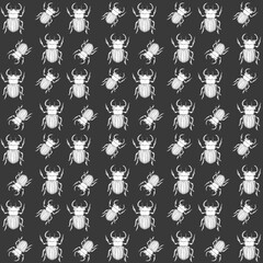 endless pattern of beetles against a dark background