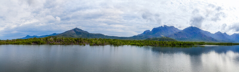 Fototapeta na wymiar Panorama overlooking the green mangrove forests against the backdrop of distant blue mountains.