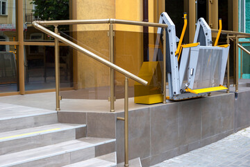 Wheelchair lift platform near the public building. Lift for disabled people