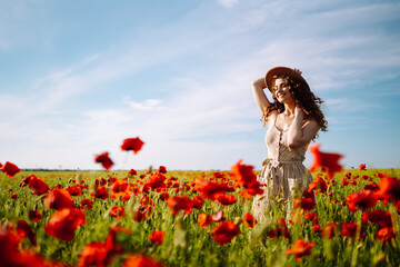 Beautiful woman in a blooming poppy field. People, lifestyle, travel, nature and vacations concept.