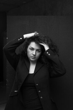 Emotional portraits of a beautiful and curly girl in a jacket