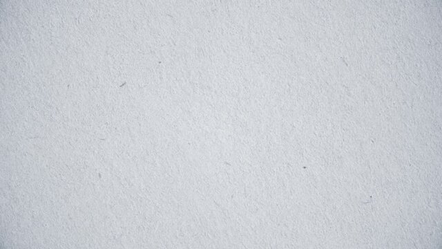 Animated texture of old white paper. Animation. Effect of old grainy paper for superimposing into animation. Template or textured background with grainy old paper