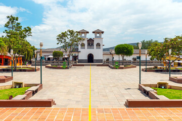 Equator line in Mitad del Mundo (Middle of the world) village with church and shops, Quito, Ecuador.