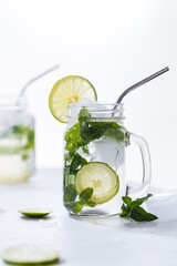 Fototapeta premium Mojito cocktails served on a bright background with lime and straw